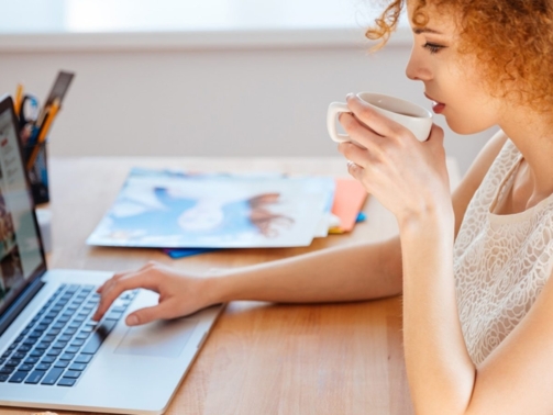 woman-photographer-drinking-coffee-and-working-PJNBP6U@2x-1600x900